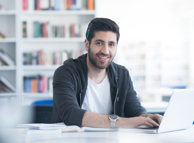 Young person using a laptop in a home office